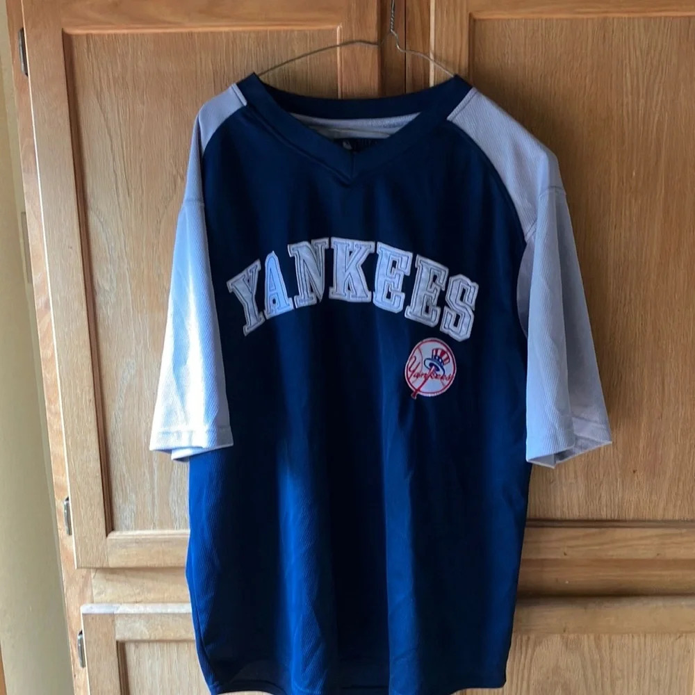YANKEES Short sleeved XL/EG v-necked pullover 100 percent polyester jersey.